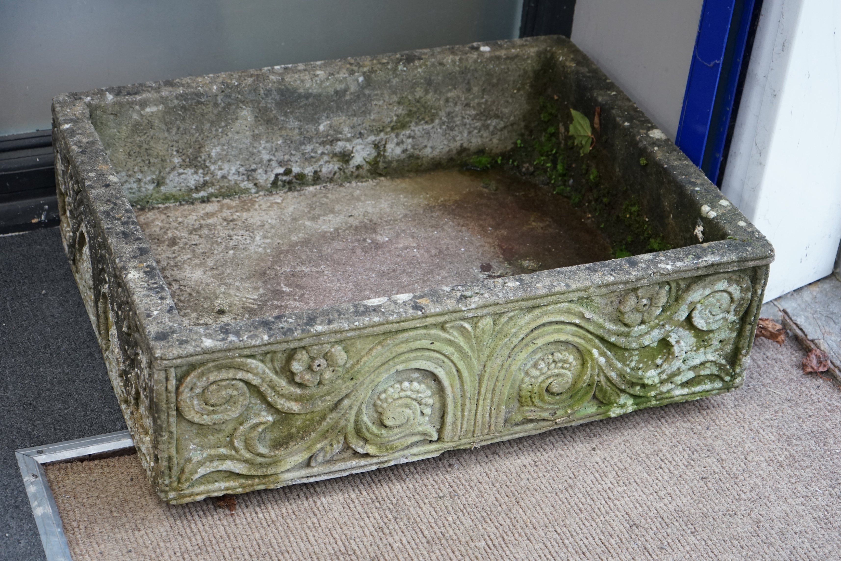 A rectangular reconstituted stone garden trough